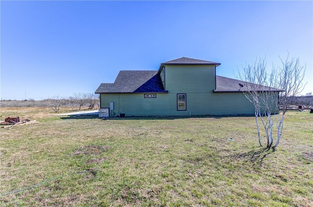 view of side of property with a yard