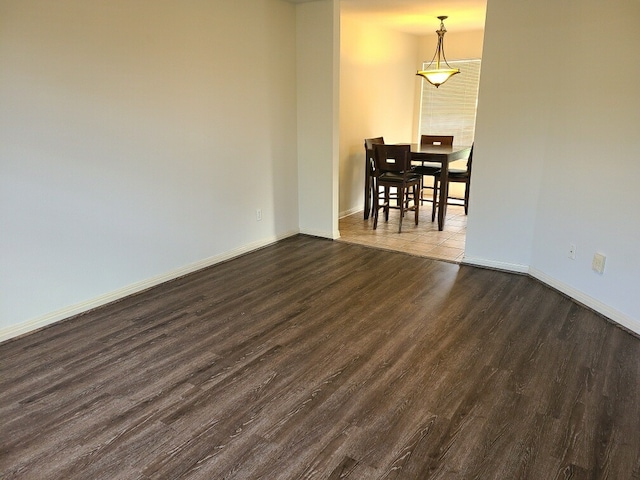 unfurnished room featuring dark hardwood / wood-style flooring