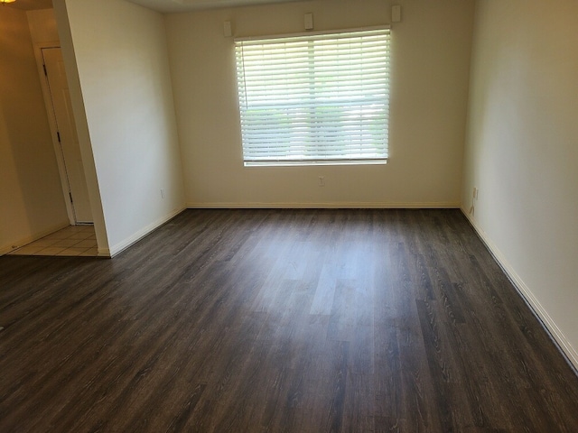 empty room with dark wood-type flooring