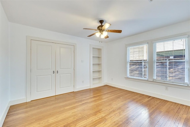 1721 Palma Plz, Austin, TX 78703 - unfurnished bedroom featuring light wood finished floors, a closet, and a ceiling fan