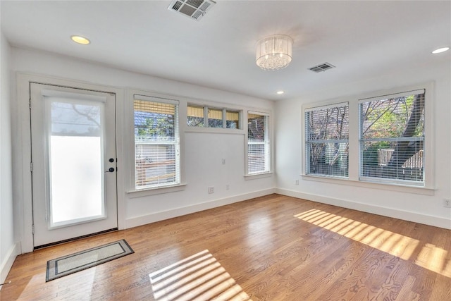 1721 Palma Plz, Austin, TX 78703 - entryway featuring healthy amount of natural light, light wood-style flooring, a chandelier, and recessed lighting