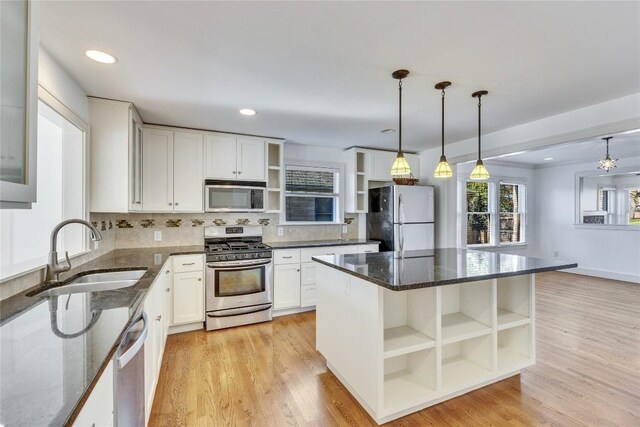 1721 Palma Plz, Austin, TX 78703 - kitchen featuring open shelves, appliances with stainless steel finishes, tasteful backsplash, white cabinets, and dark stone counters