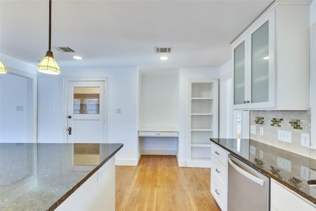 1721 Palma Plz, Austin, TX 78703 - kitchen with dishwasher, white cabinets, decorative light fixtures, dark stone counters, and light wood finished floors