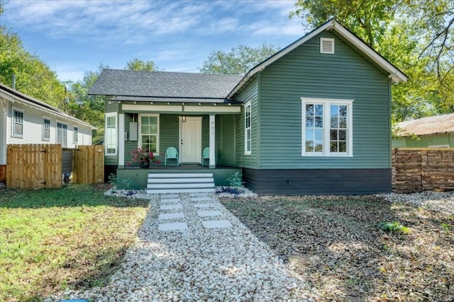 bungalow with a porch and a front yard