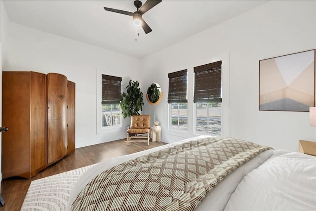 bedroom with ceiling fan and dark hardwood / wood-style floors