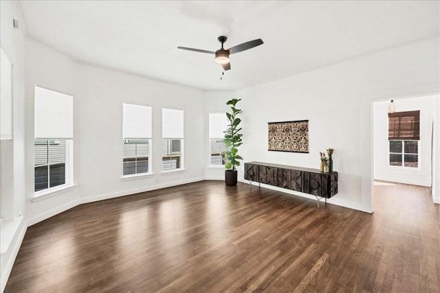 unfurnished living room with ceiling fan and dark wood-type flooring