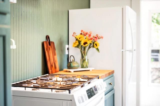 interior space featuring white appliances and wood counters