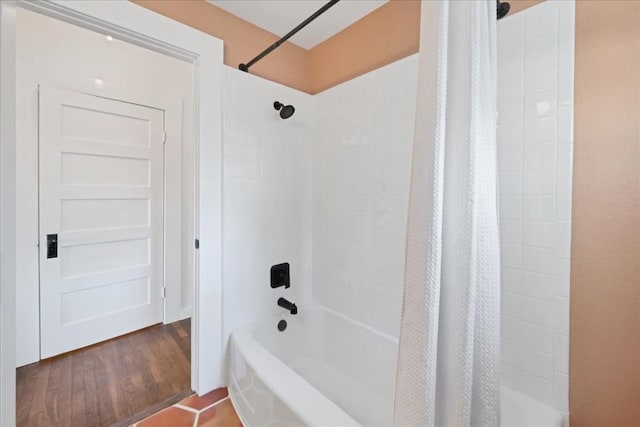 bathroom with wood-type flooring and shower / tub combo with curtain