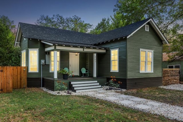 view of front facade featuring a porch and a yard