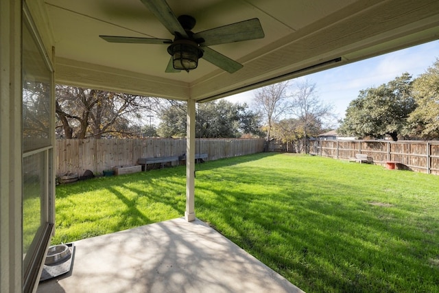 view of yard featuring ceiling fan and a patio