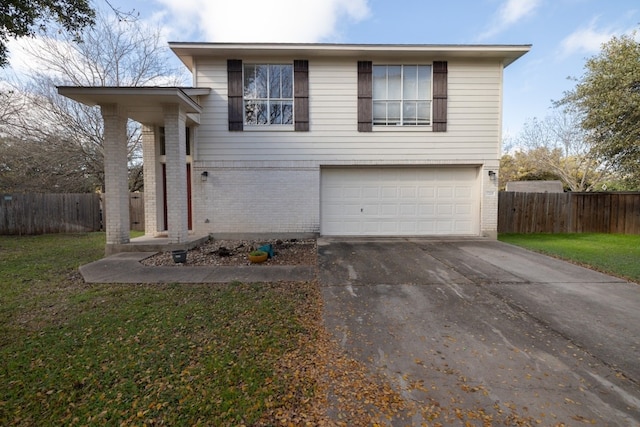 view of front of house featuring a front lawn and a garage