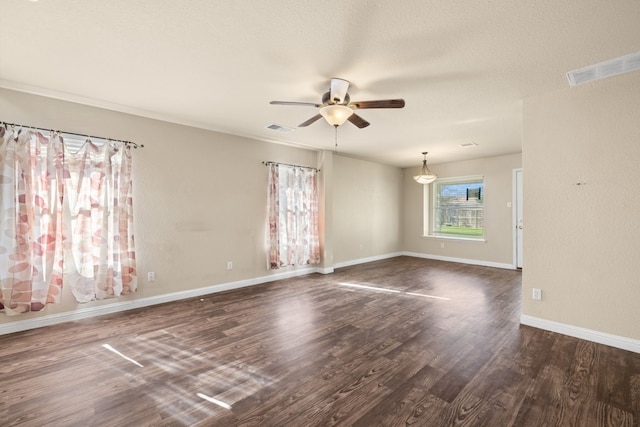 unfurnished room featuring a textured ceiling, ceiling fan, and dark hardwood / wood-style floors