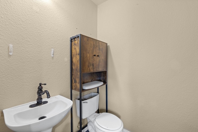 bathroom with toilet and sink