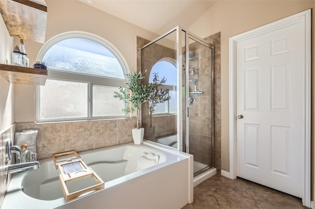 bathroom with tile patterned flooring, a shower with door, and vaulted ceiling