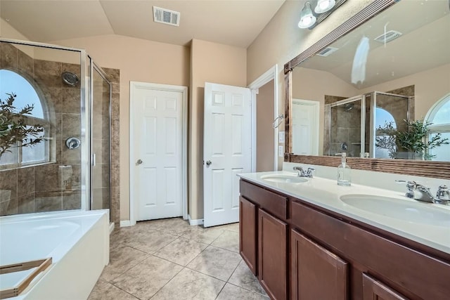 bathroom featuring tile patterned floors, vanity, shower with separate bathtub, and vaulted ceiling