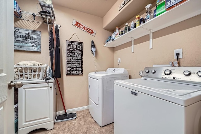 laundry room with independent washer and dryer and light tile patterned floors