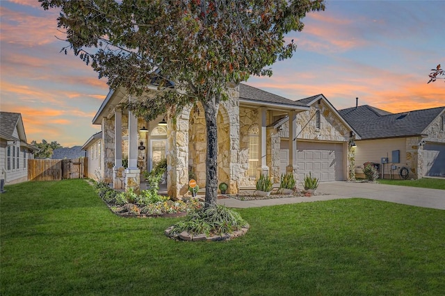 view of front of property featuring a yard and a garage