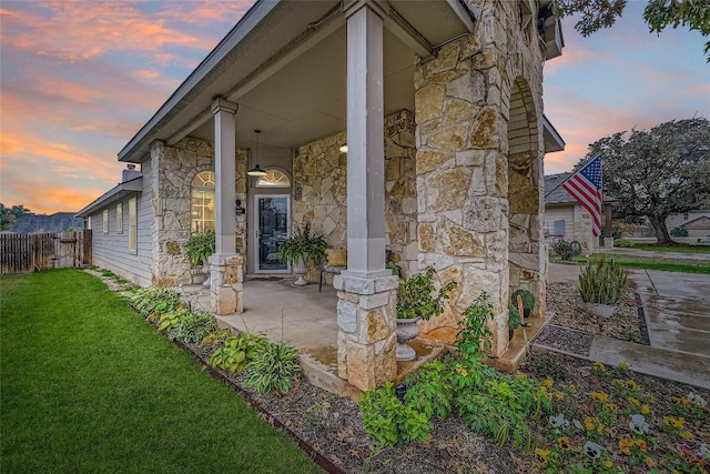 exterior space with covered porch and a yard