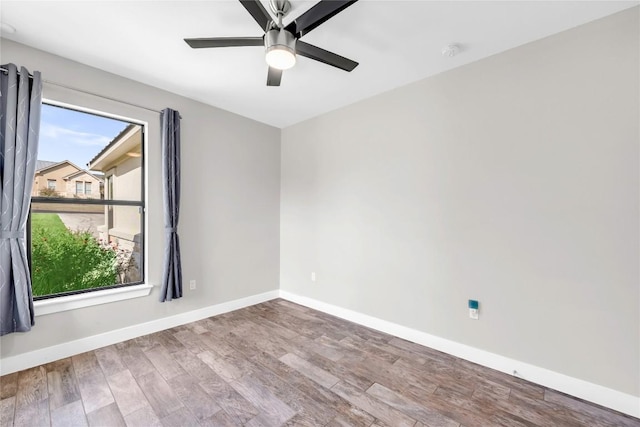 spare room with ceiling fan and wood-type flooring