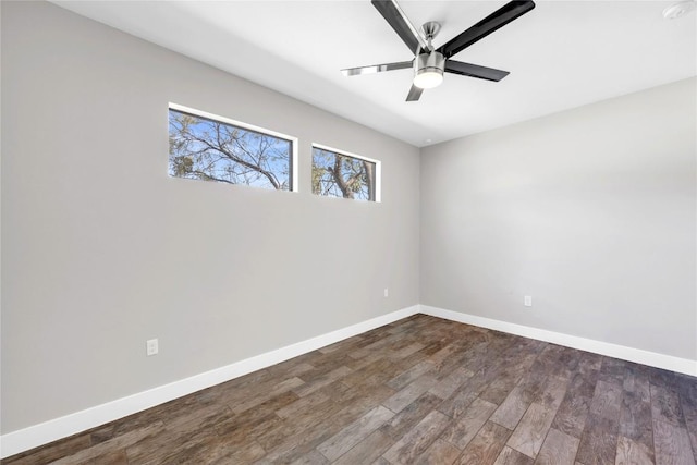 empty room featuring dark hardwood / wood-style flooring and ceiling fan