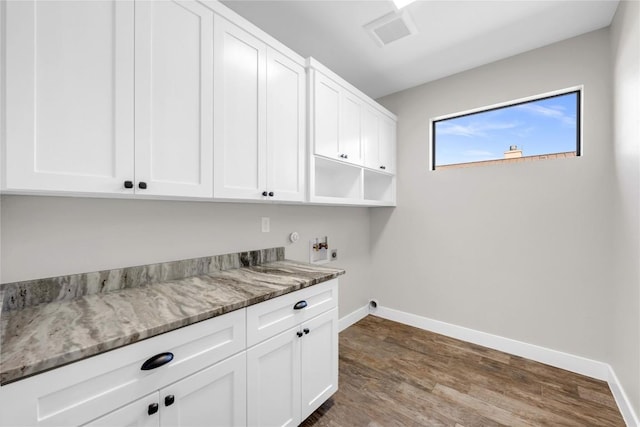 washroom featuring hookup for a washing machine, cabinets, and hardwood / wood-style flooring