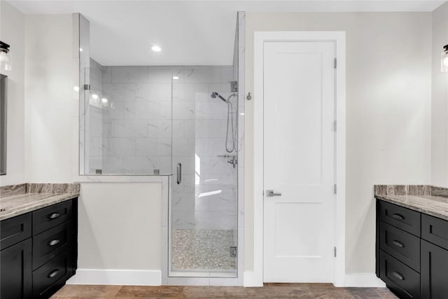 bathroom with vanity and a shower with door