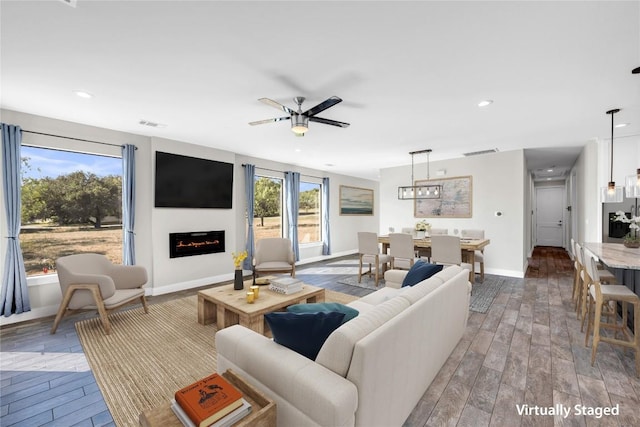 living room with wood-type flooring and ceiling fan