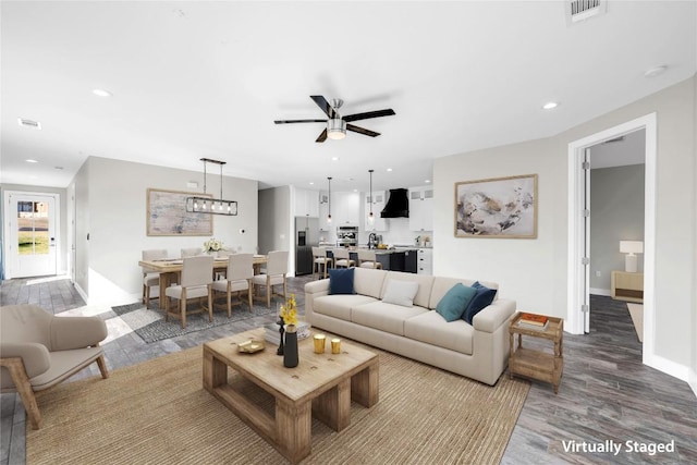 living room featuring hardwood / wood-style floors and ceiling fan