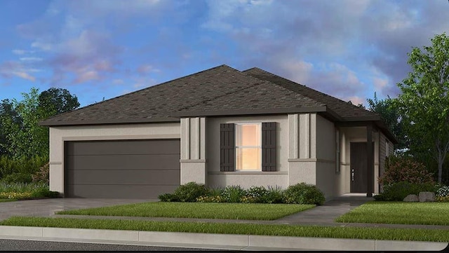 view of front of home featuring a lawn and a garage