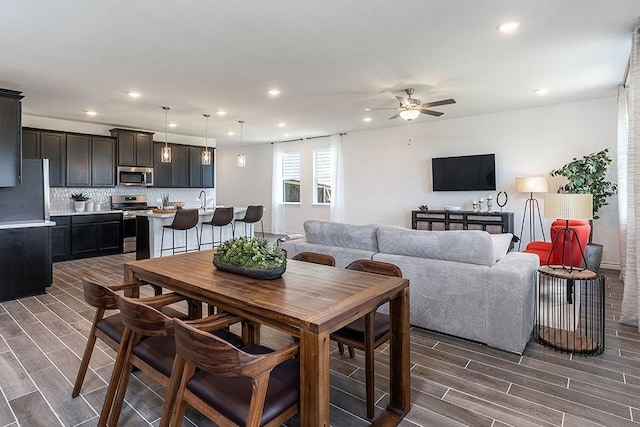 dining area featuring ceiling fan and dark hardwood / wood-style flooring