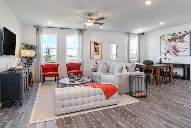 living room featuring ceiling fan and dark hardwood / wood-style flooring