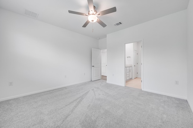 1804 Lorant Ln, Pflugerville, TX 78660 - unfurnished bedroom featuring light colored carpet, baseboards, ensuite bath, and a ceiling fan