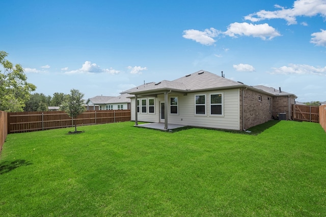 1804 Lorant Ln, Pflugerville, TX 78660 - back of property featuring a fenced backyard, a patio area, and brick siding