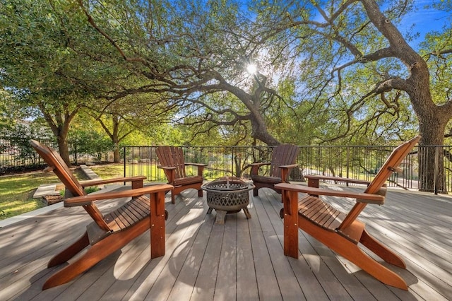 wooden terrace featuring a fire pit