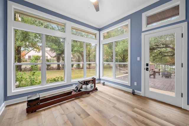 unfurnished sunroom with ceiling fan