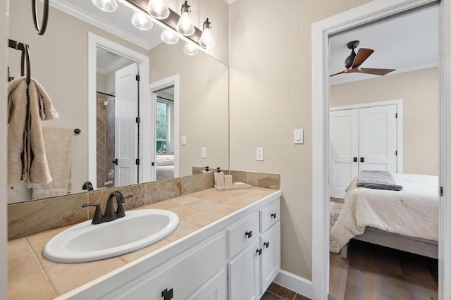 bathroom featuring curtained shower, ceiling fan, wood-type flooring, vanity, and ornamental molding