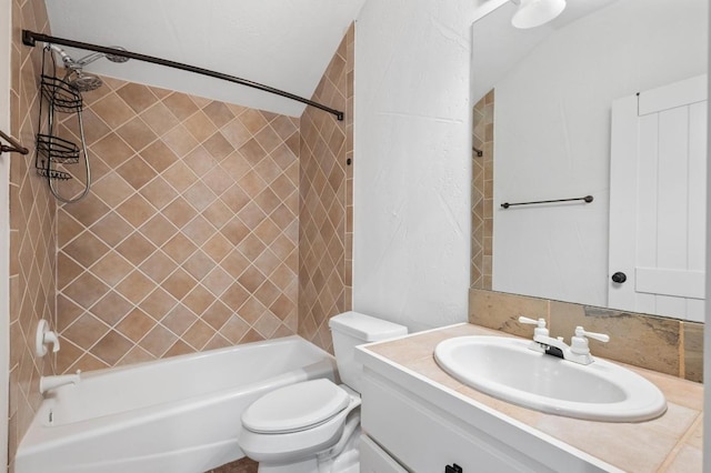 full bathroom featuring toilet, vanity, and tiled shower / bath