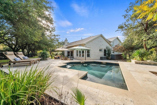 rear view of property with outdoor lounge area and a patio area