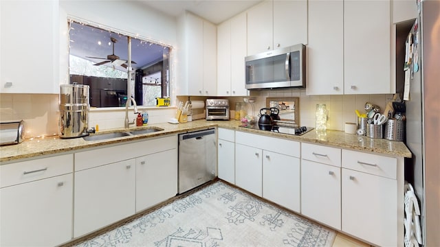 7 Hull Circle Dr, Austin, TX 78746 - kitchen with stainless steel appliances, a sink, backsplash, and white cabinets