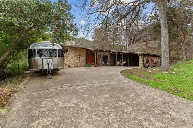 7 Hull Circle Dr, Austin, TX 78746 - view of front of property featuring concrete driveway and stone siding