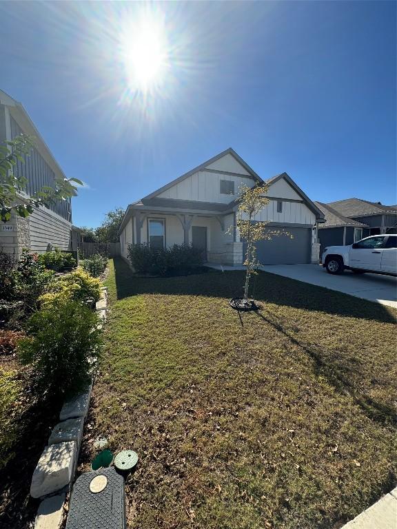 view of front of home featuring a garage and a front lawn