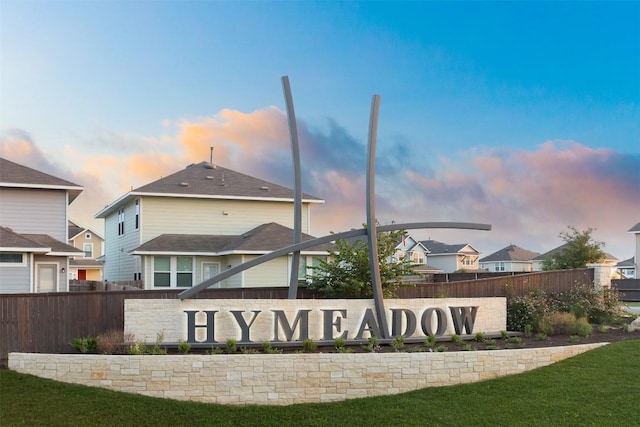 community sign featuring a lawn