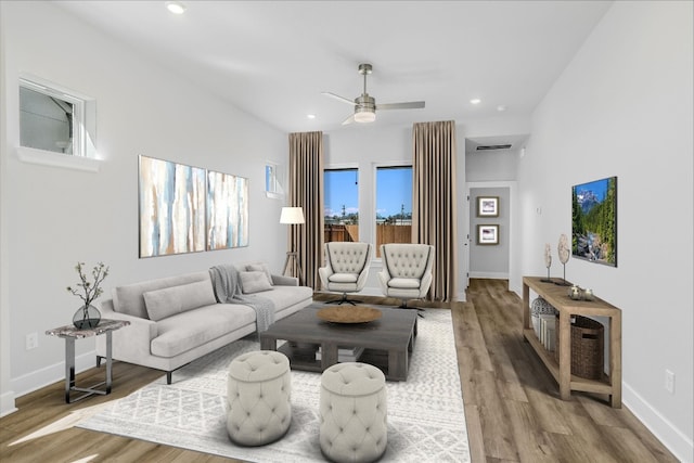 living room featuring ceiling fan and hardwood / wood-style floors
