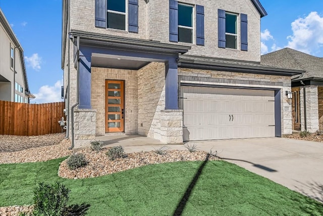 view of front of home with a garage and a front yard