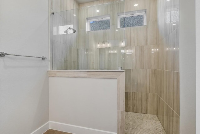 bathroom with tiled shower
