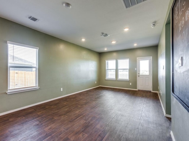 spare room featuring dark wood-type flooring