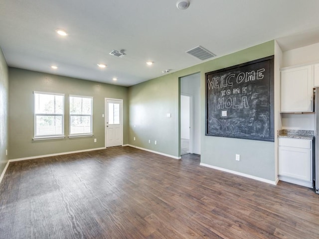 unfurnished living room featuring dark hardwood / wood-style floors