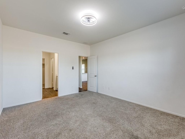 unfurnished bedroom with light colored carpet