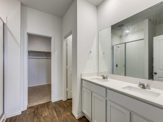 bathroom featuring vanity, wood-type flooring, and an enclosed shower