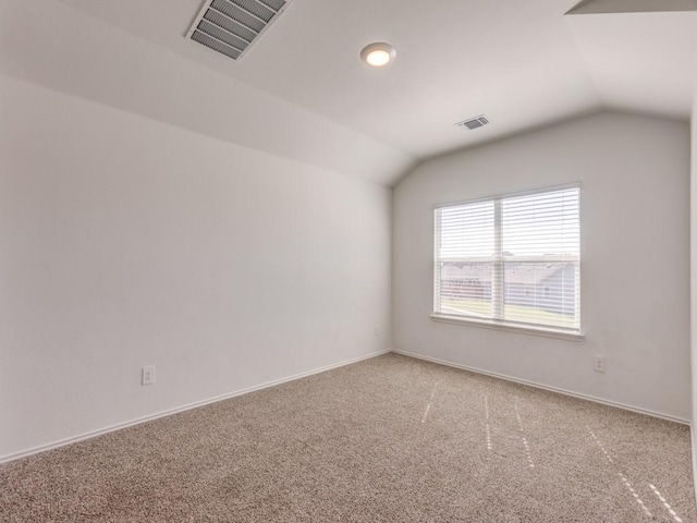 carpeted spare room with lofted ceiling